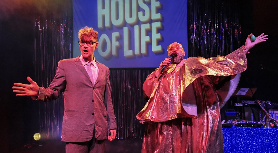 House of Life backdrop with a clown and a man in a suit