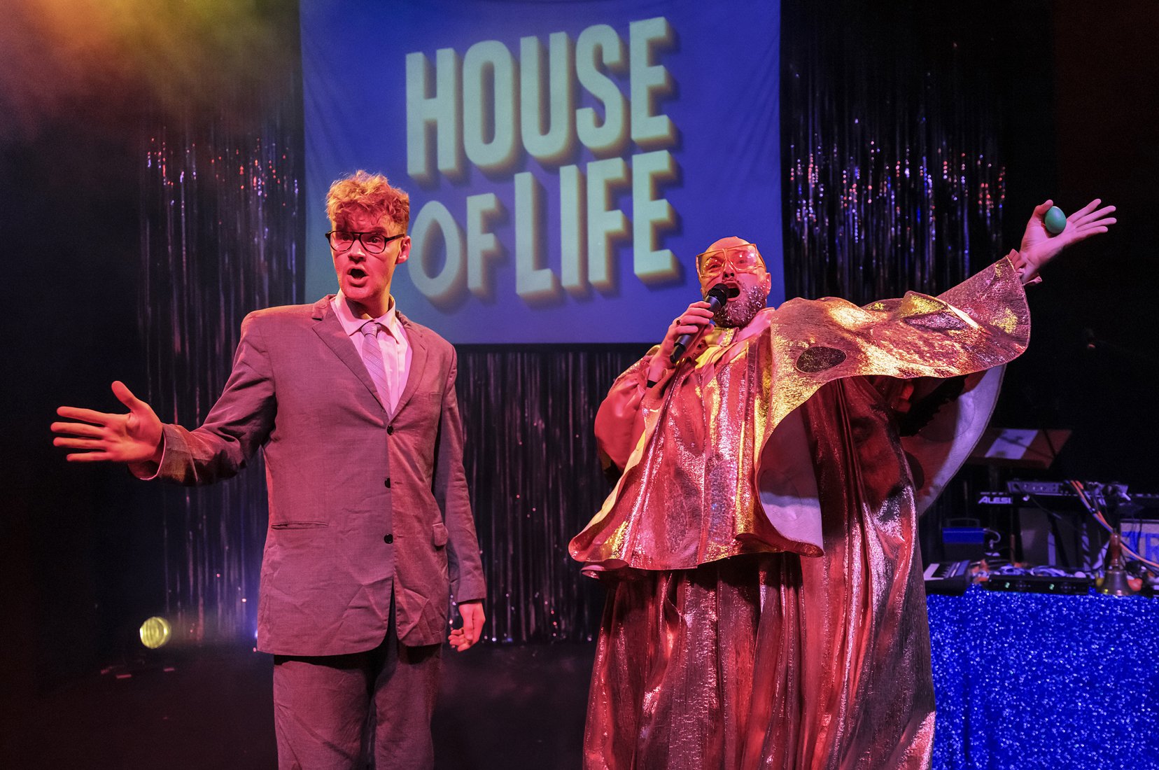 House of Life backdrop with a clown and a man in a suit