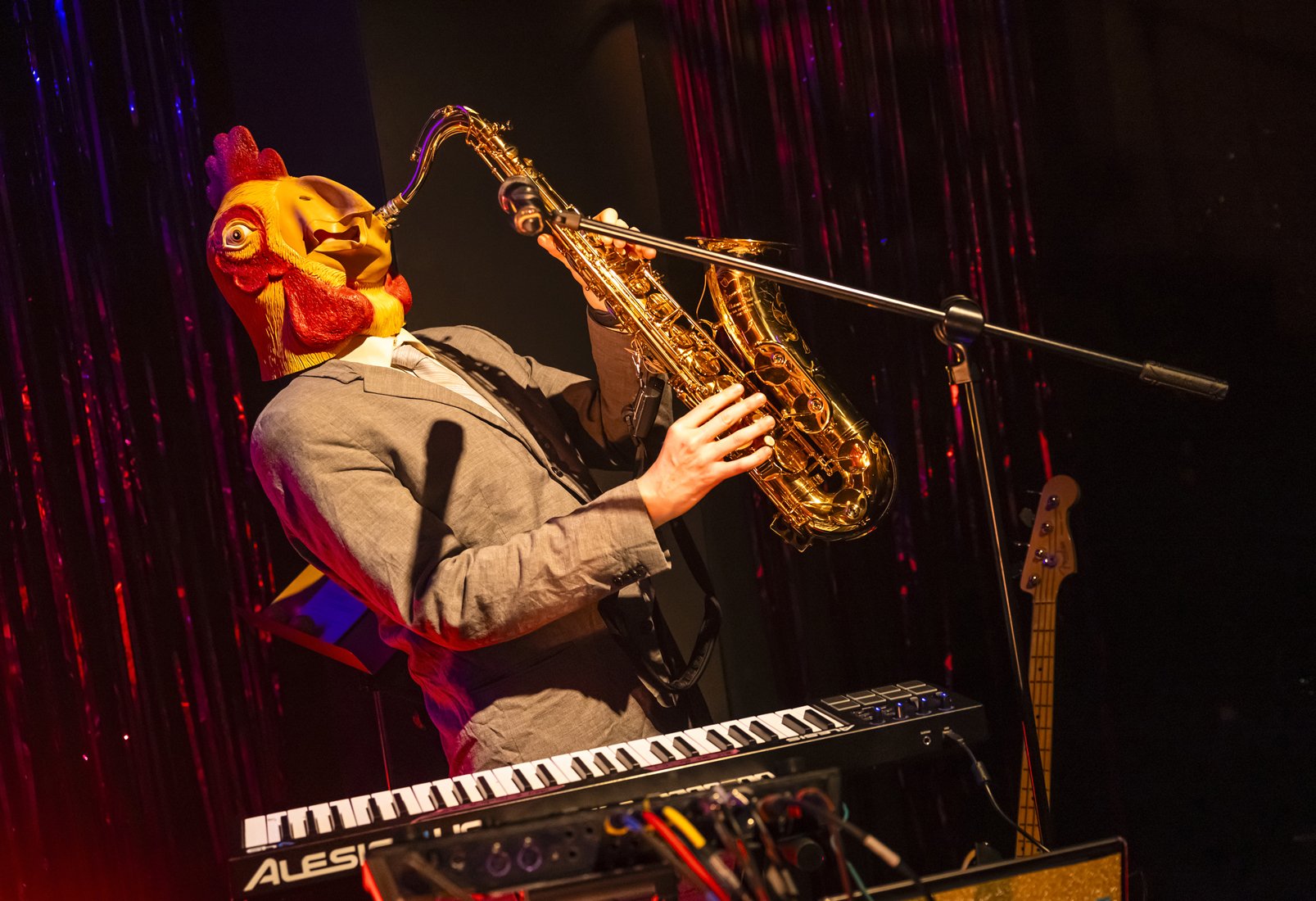 A giant chicken playing a saxaphone