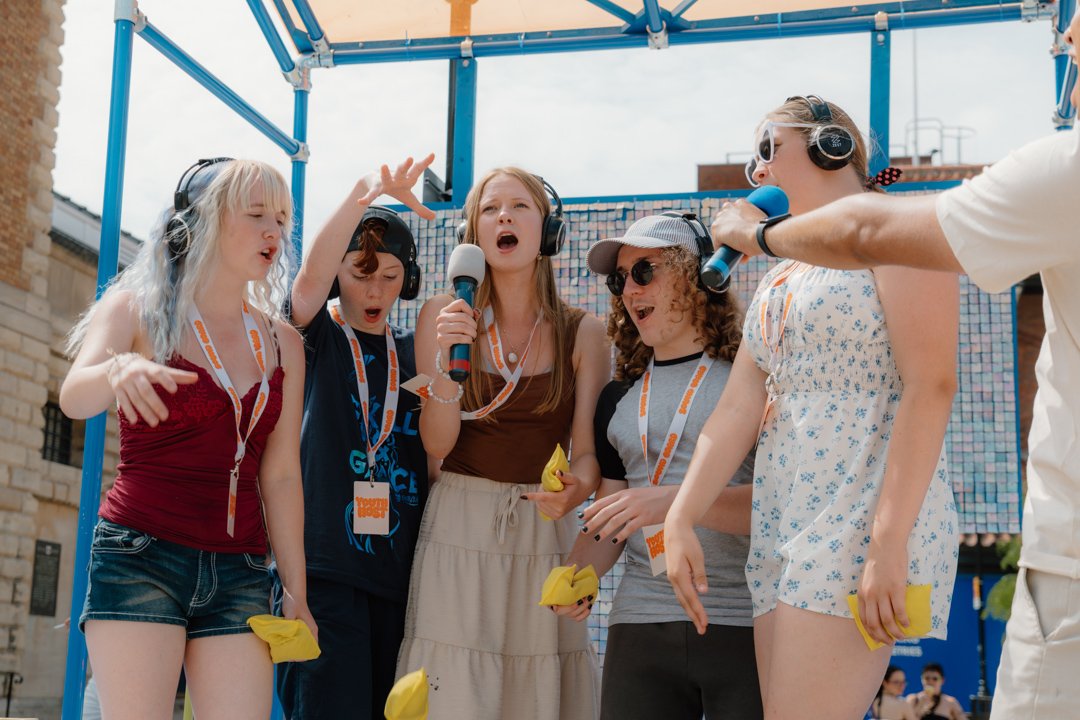 a group of kids with mics singing
