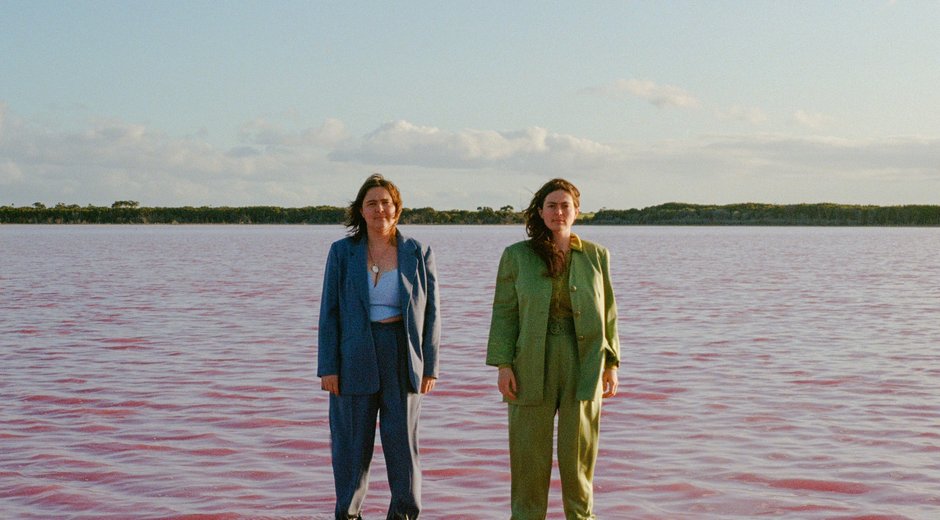 The Maes standing in the ocean, just up to the knee