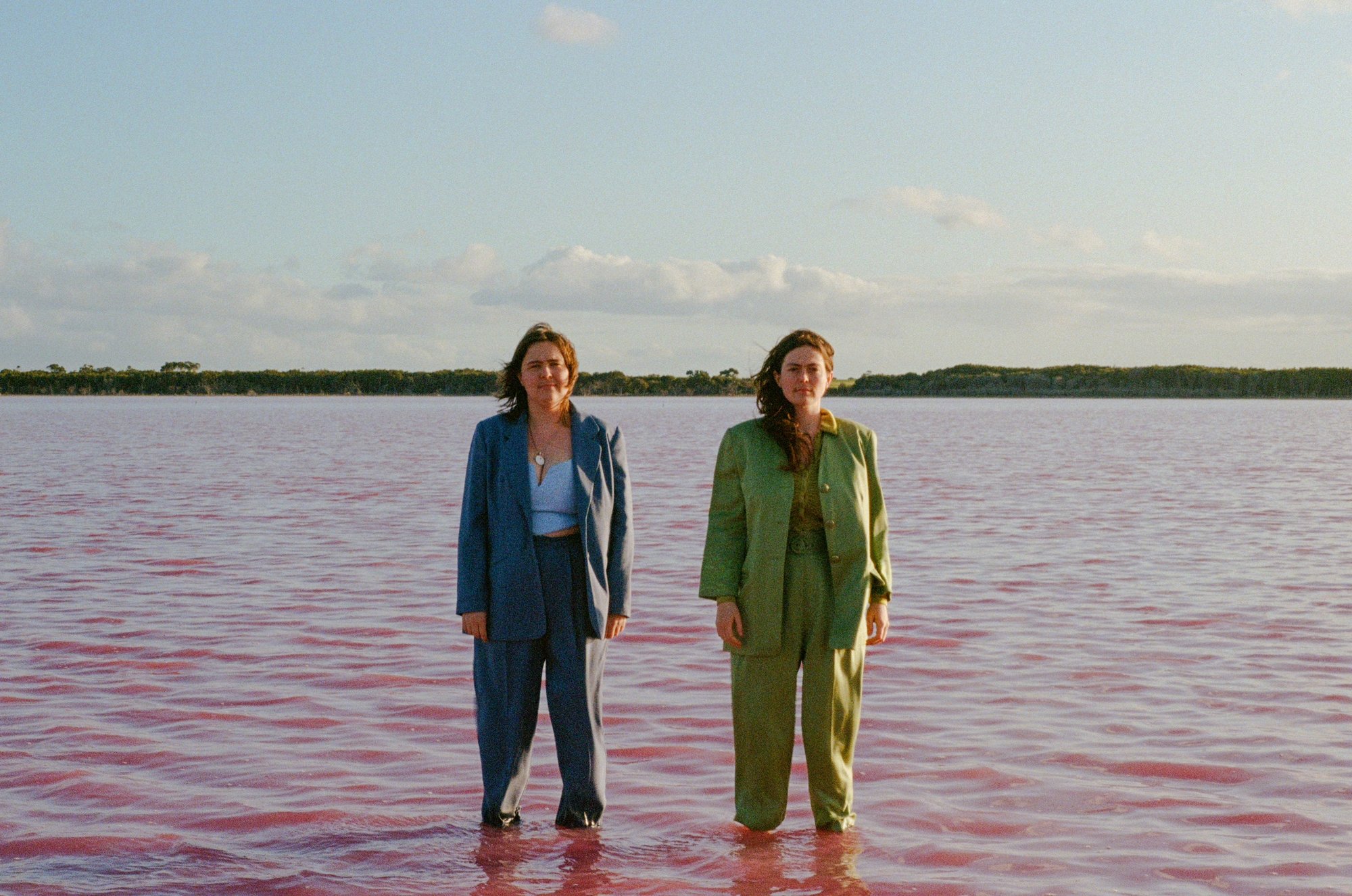 The Maes standing in the ocean, just up to the knee