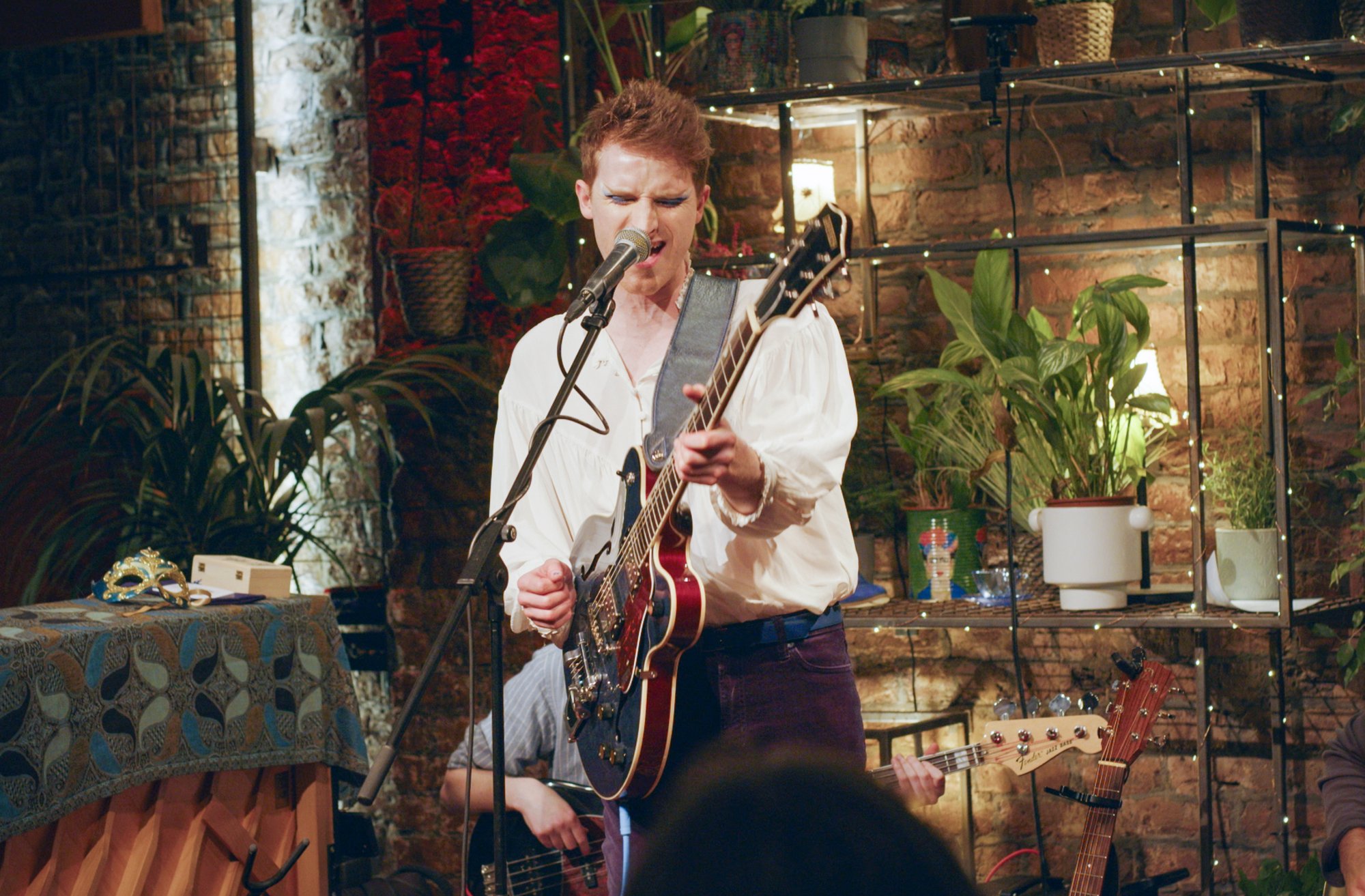 Bay Bryan performing with a guitar