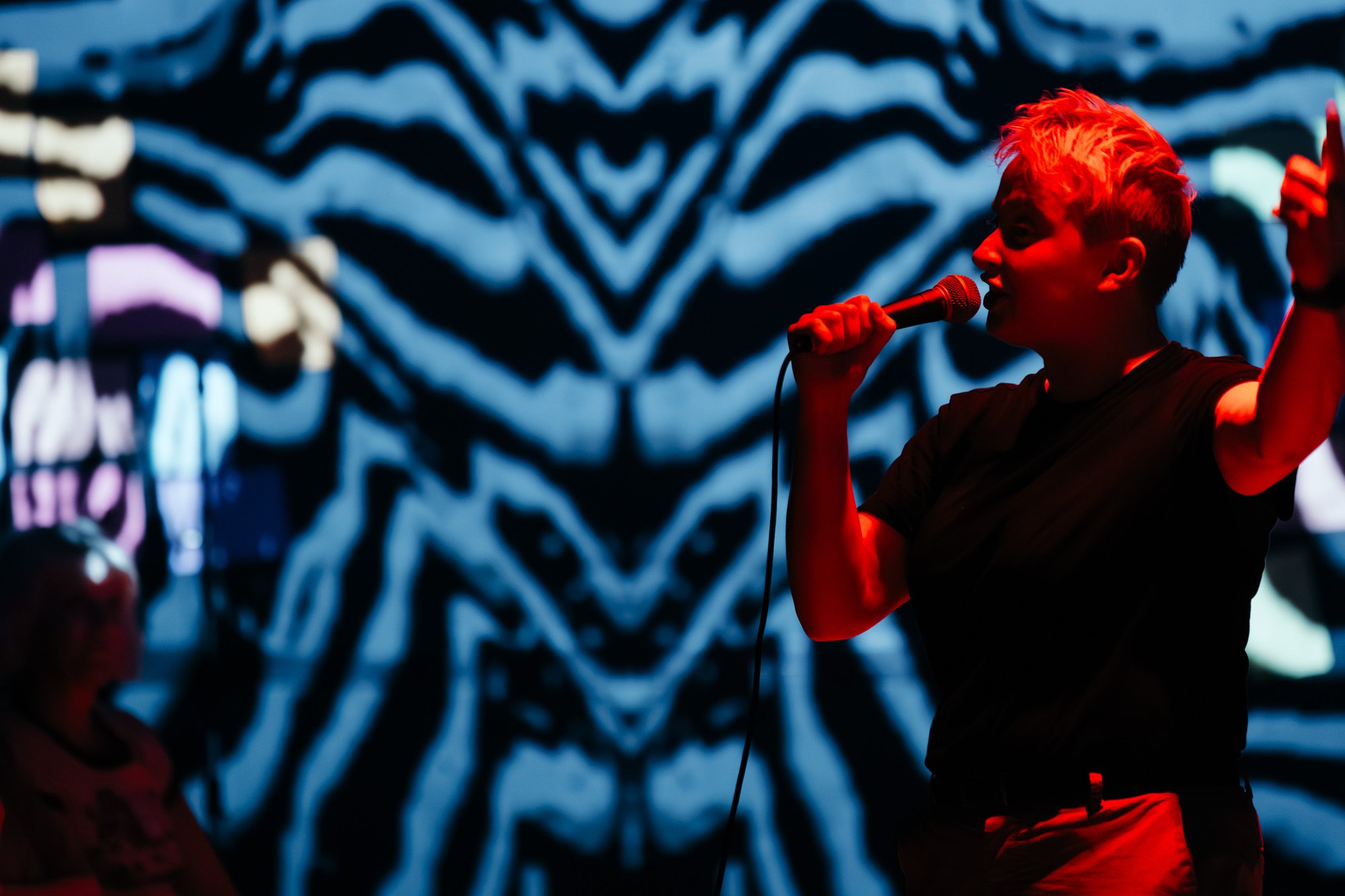 a person lit by a red light on a blue background