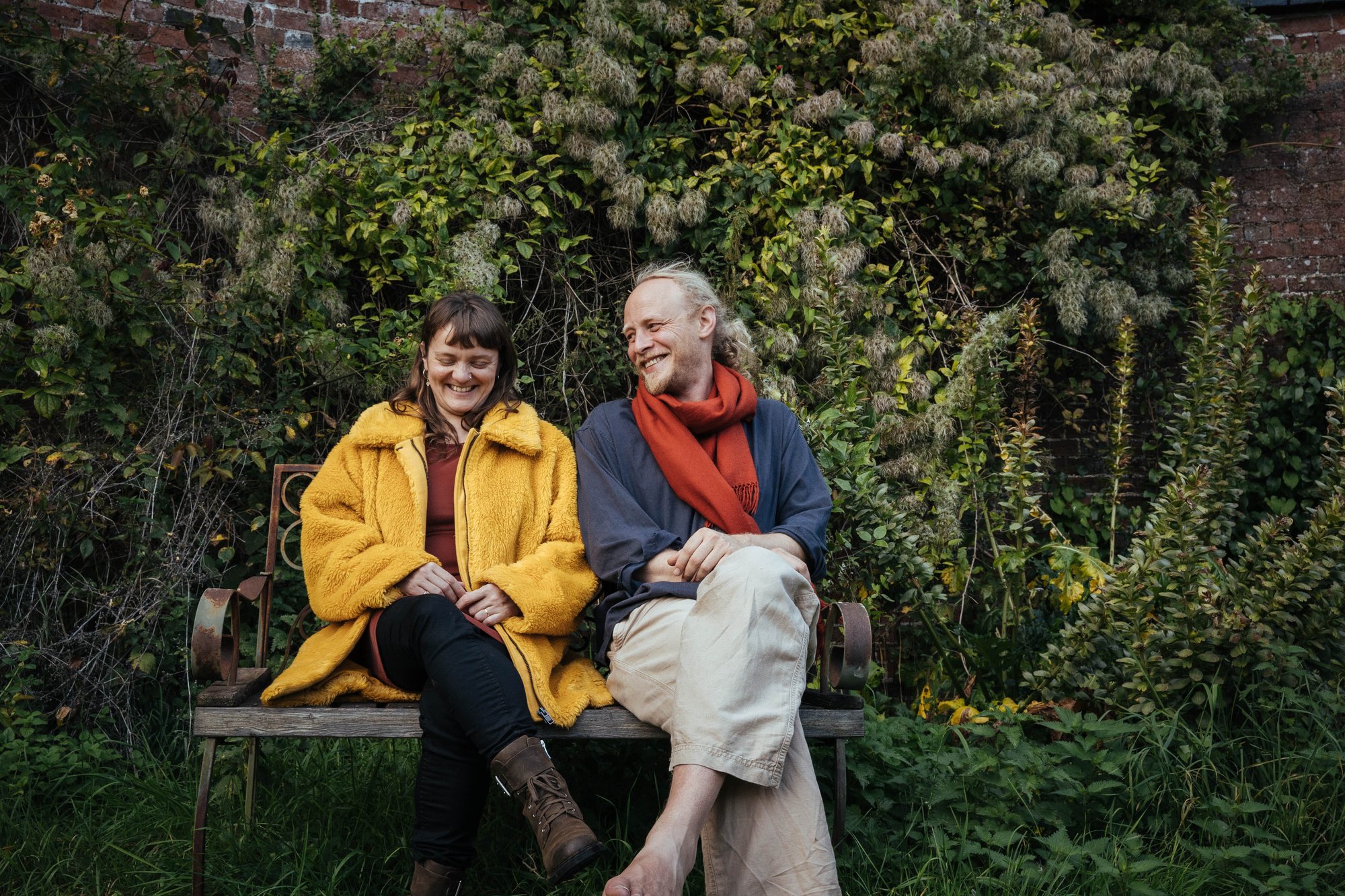 Hannah and James sat on a bench in a garden