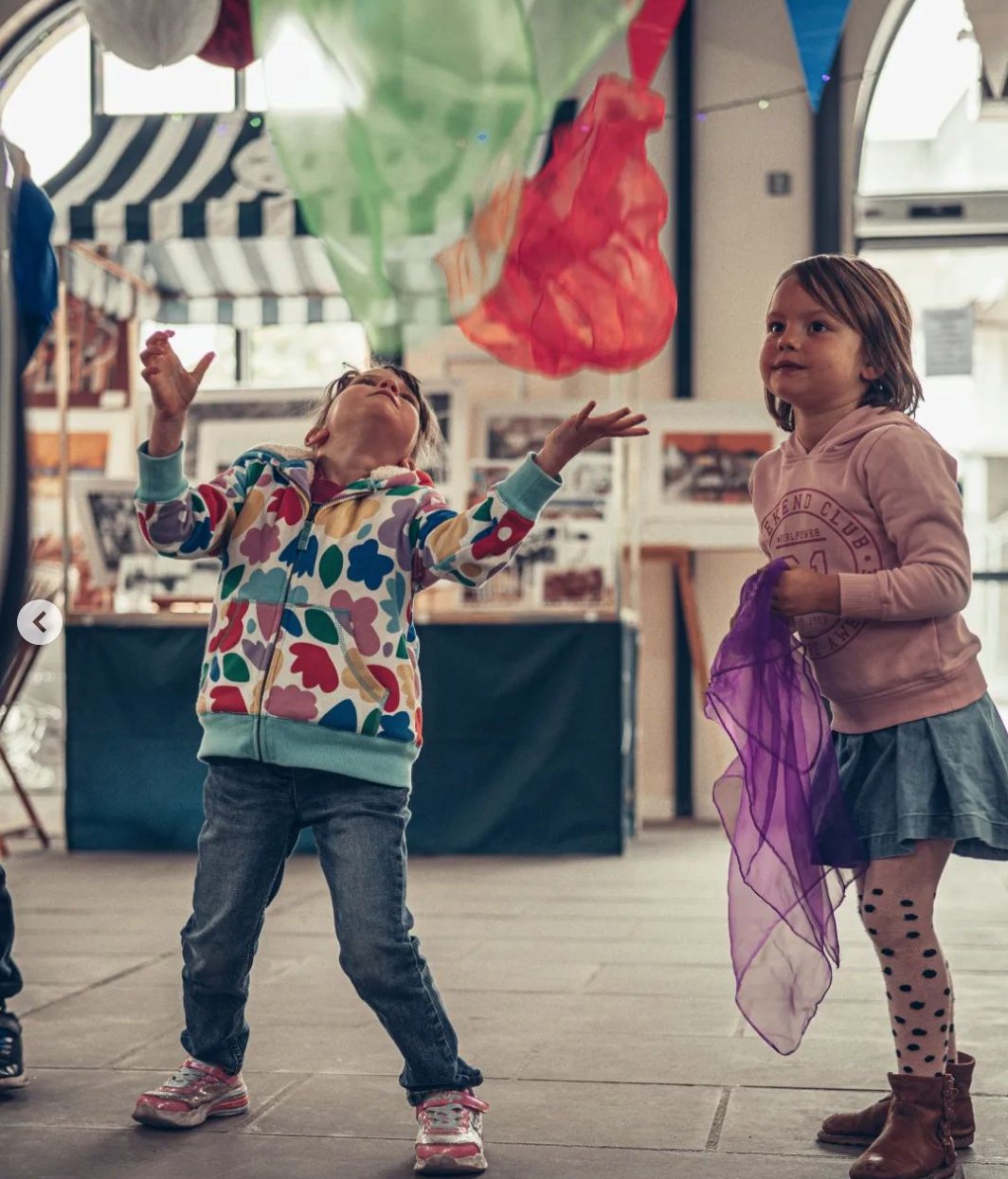 Children taking part in a hands-on circus skills workshop.
