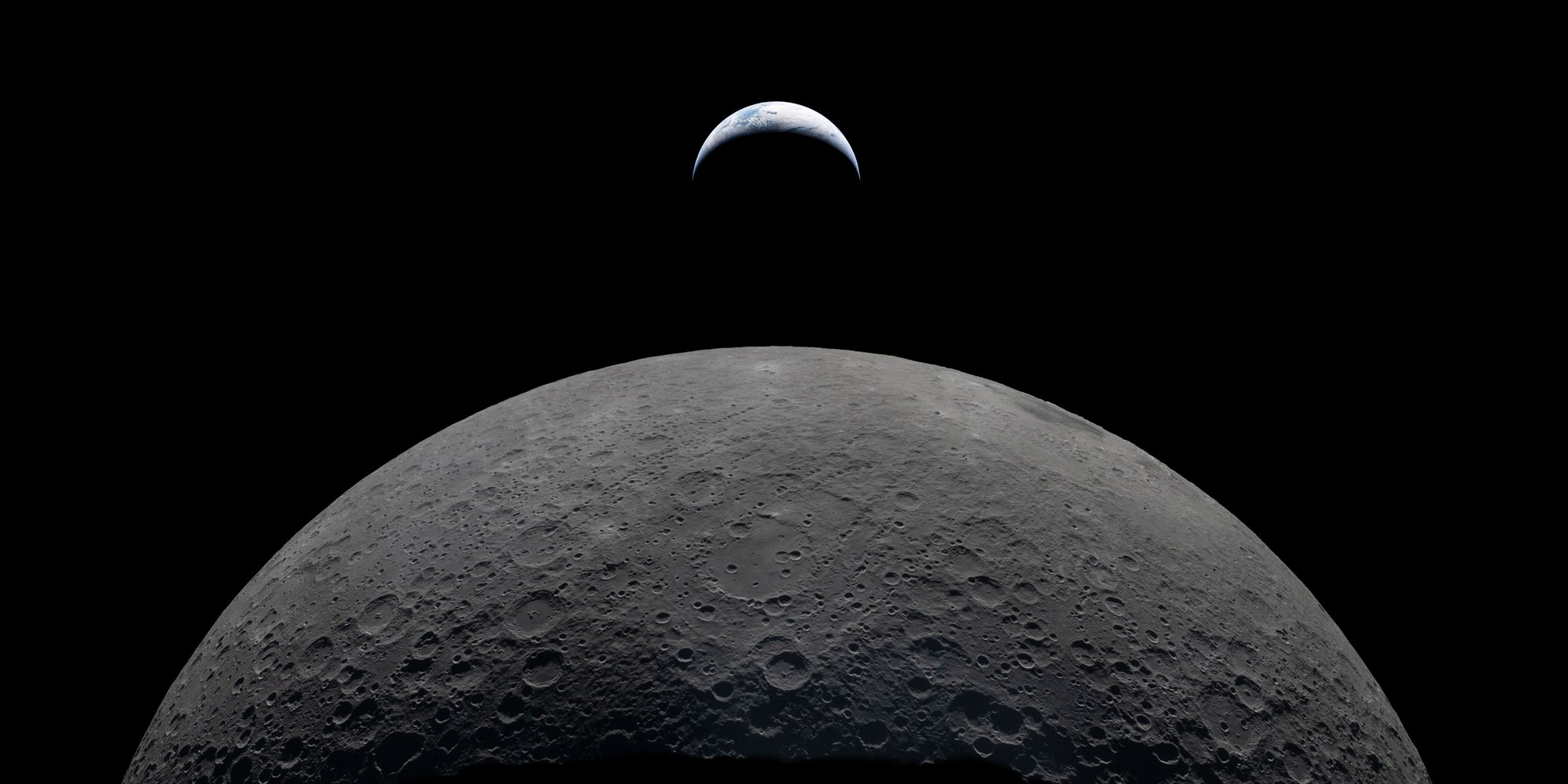 A detailed image of the Moon's crater-covered surface against a black sky, with a partially illuminated Earth rising above the lunar horizon.