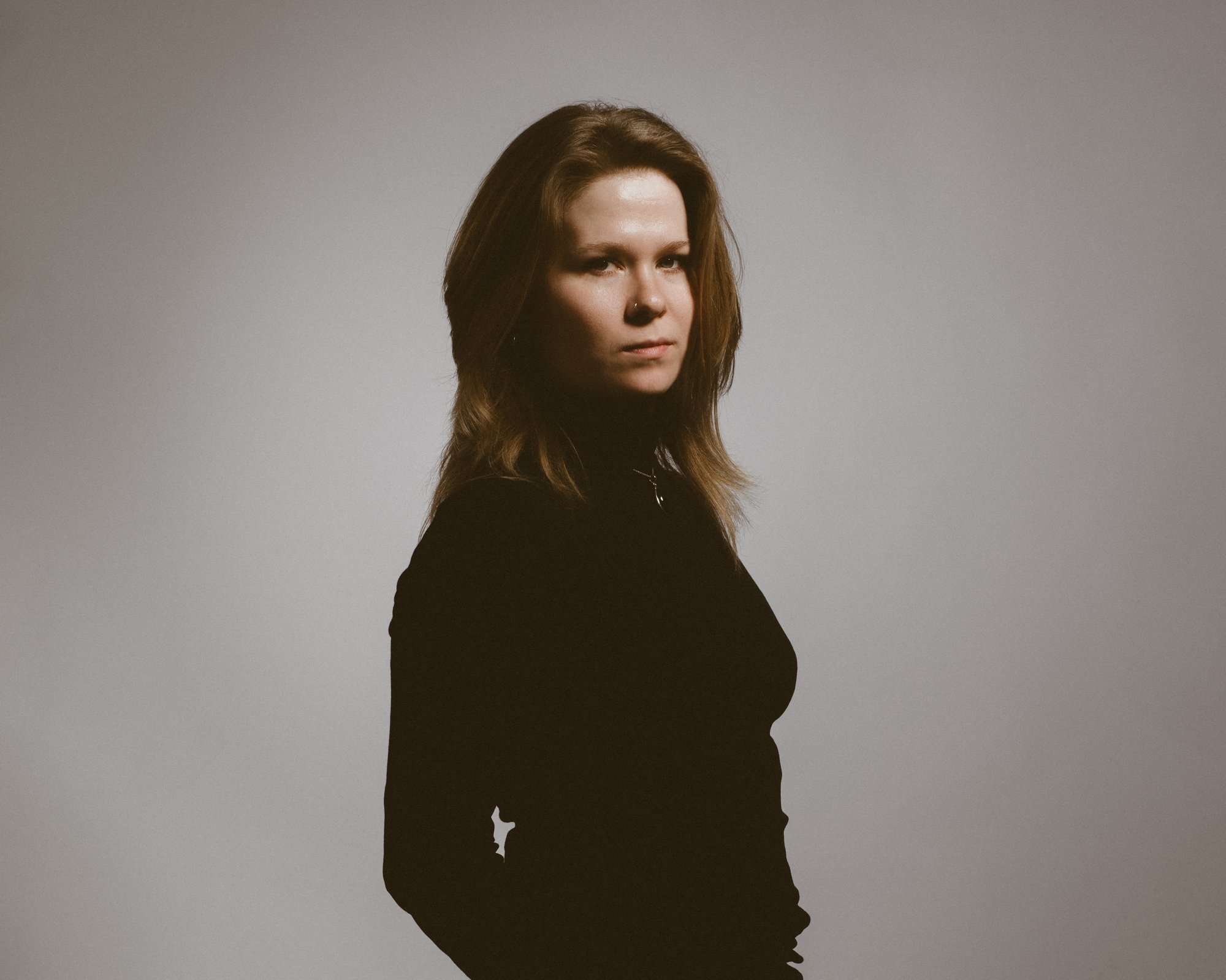 Katie Spencer dressed in black looking at the camera