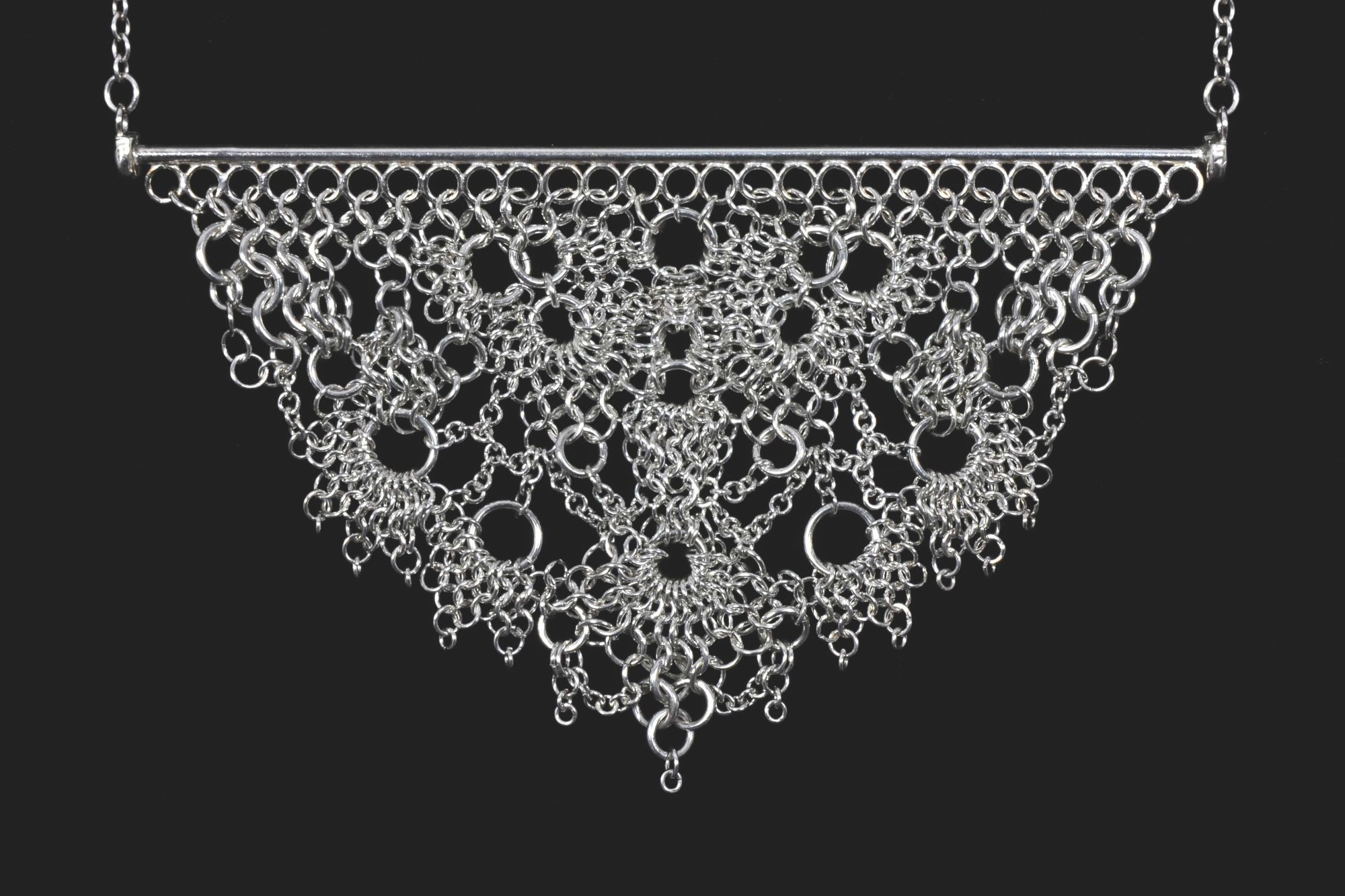It’s a piece of handcrafted chainmail jewelry — delicate, symmetrical, and impressively intricate