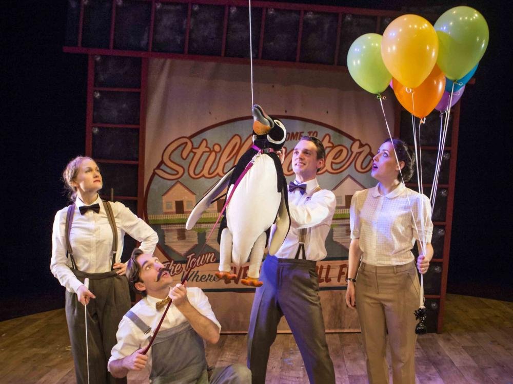 Penguin floating with balloon