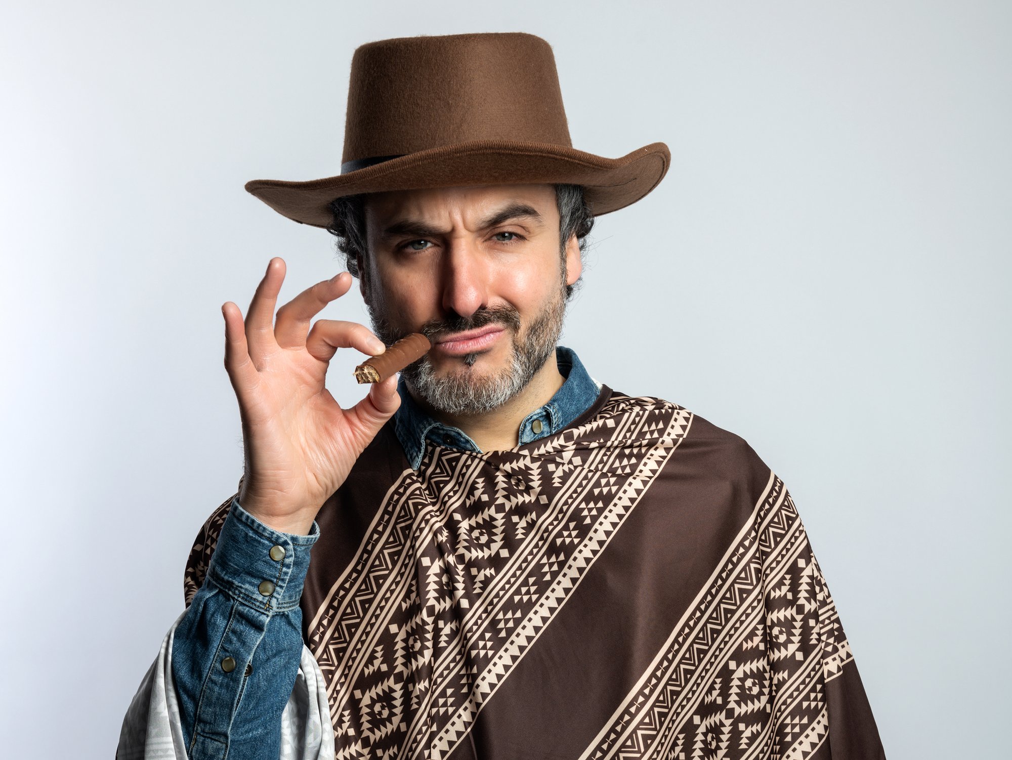 Patrick dressed as a cowboy holding a cigar