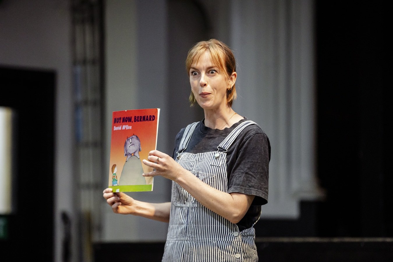 a woman holding David Mckee's Not Now Bernard book