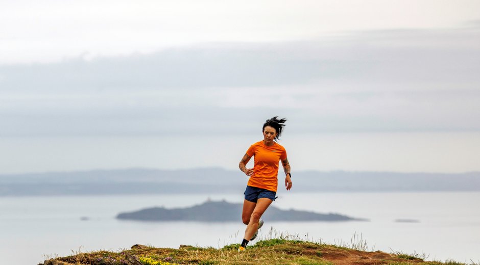 Allie Bailey running along a cliff edge