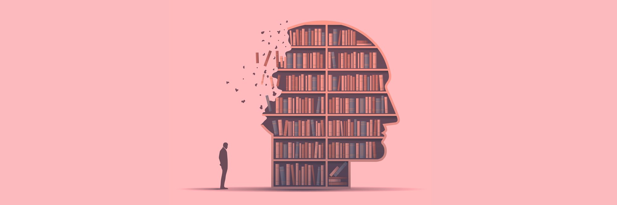A man stood next to a giant head full of bookshelves